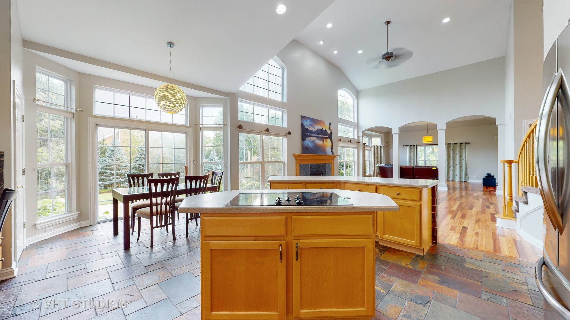 305 Saddle Lane Fox River Grove, IL 60021 - Photo 21 of 55 a dining hall with stainless steel appliances granite countertop a stove and a dining table with wooden floor