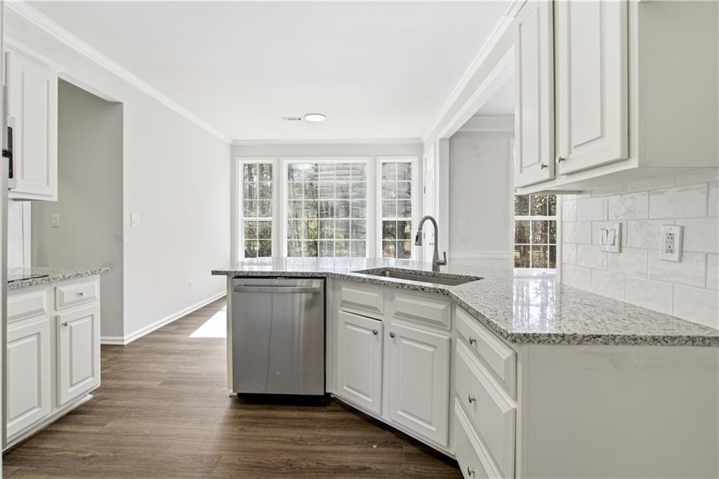 2296 Talbot Ridge Jonesboro, GA 30236 - Photo 18 of 44 a kitchen with granite countertop a sink and cabinets with wooden floor