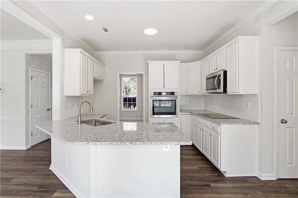 2296 Talbot Ridge Jonesboro, GA 30236 - Photo 2 of 44 a kitchen with stainless steel appliances granite countertop a sink and refrigerator
