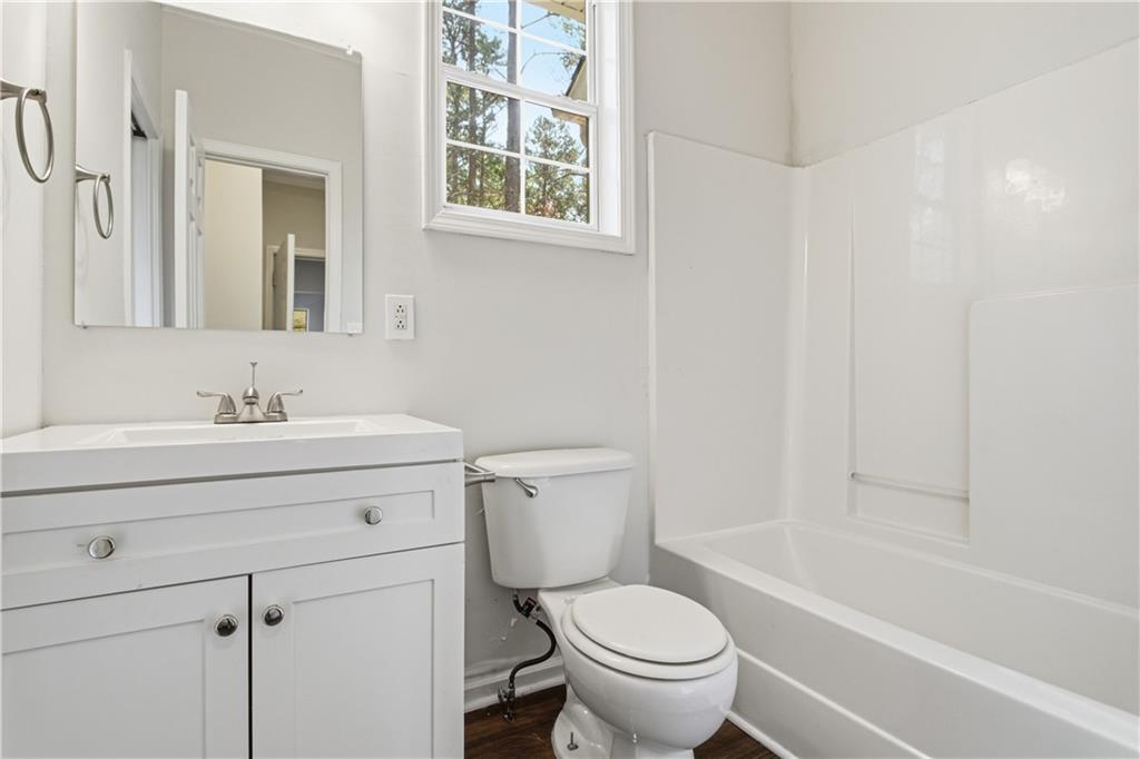 2296 Talbot Ridge Jonesboro, GA 30236 - Photo 32 of 44 a bathroom with a sink toilet a mirror and shower
