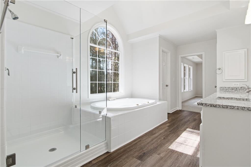 2296 Talbot Ridge Jonesboro, GA 30236 - Photo 33 of 44 a spacious bathroom with a granite countertop tub and a shower
