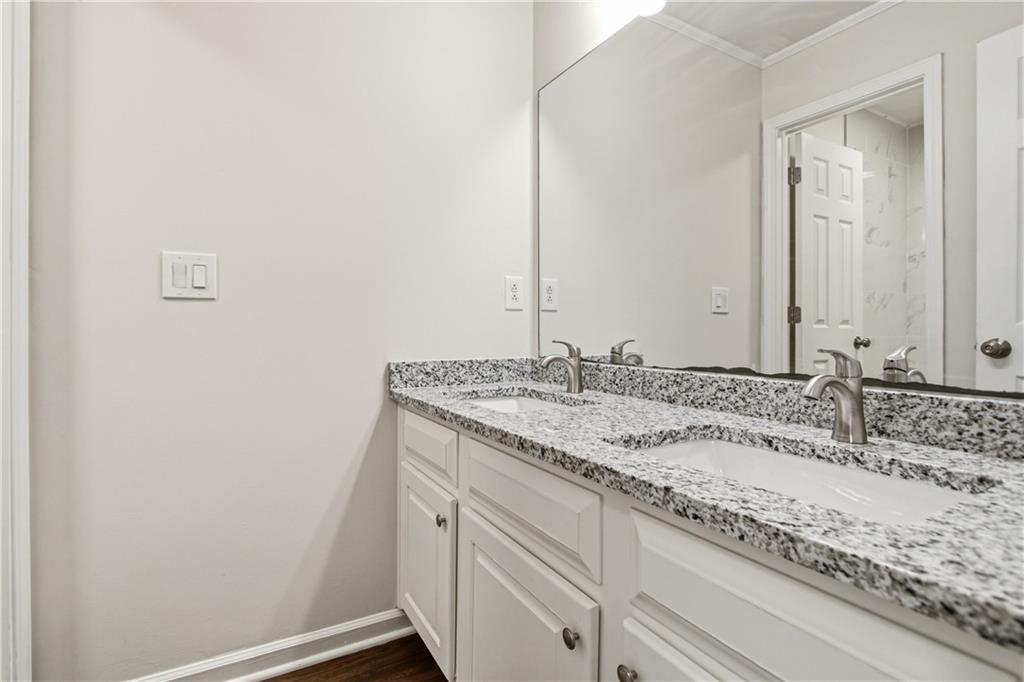 2296 Talbot Ridge Jonesboro, GA 30236 - Photo 34 of 44 a bathroom with a granite countertop sink and a mirror