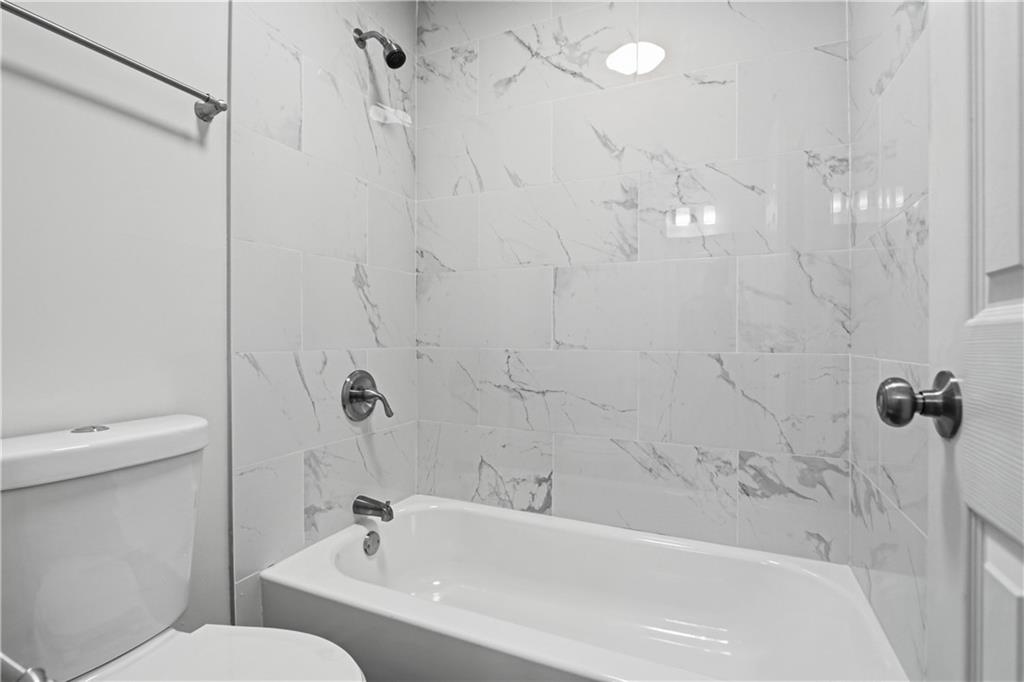 2296 Talbot Ridge Jonesboro, GA 30236 - Photo 35 of 44 a bathroom with a bathtub and shower