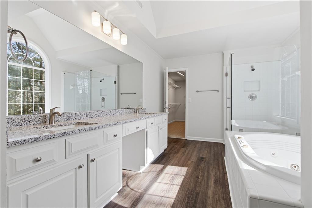 2296 Talbot Ridge Jonesboro, GA 30236 - Photo 6 of 44 a bathroom with a granite countertop bathtub a sink and a large mirror