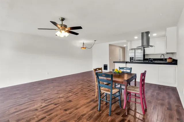 a view of a dining room with furniture and wooden floor