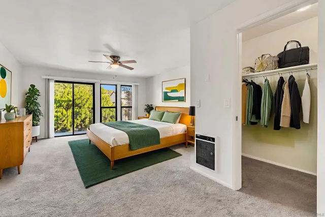 a bedroom with a bed and a view of walk in closet