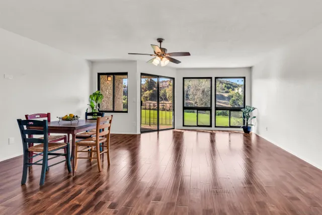a view of a dining room with furniture wooden floor and chandelier