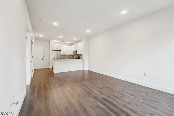 a view of a kitchen with wooden floor