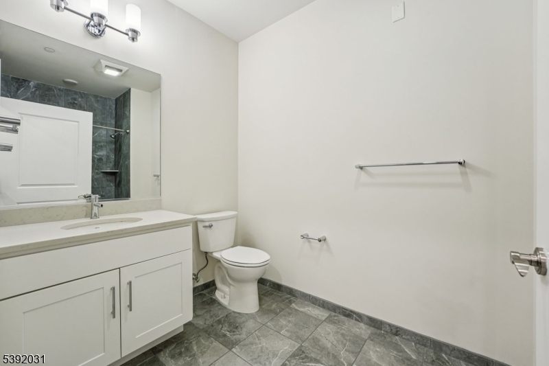 41 West Prospect Street Waldwick, NJ 07463 - Photo 9 of 19 a bathroom with a toilet a sink and mirror