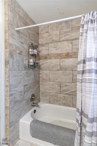 a bathroom with a white bathtub