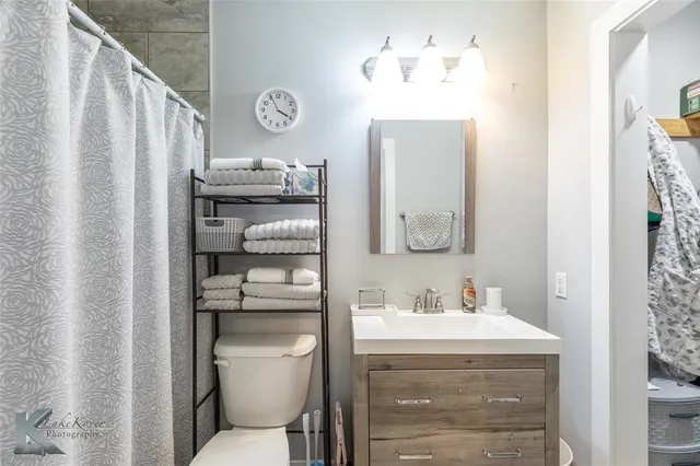 a bathroom with a toilet a sink and a mirror