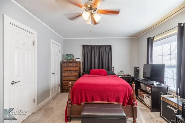 a bedroom with a bed and a flat tv screen