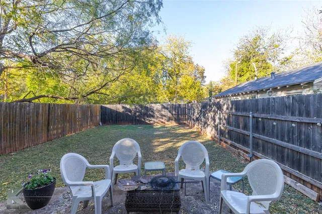 a backyard of a house with outdoor seating