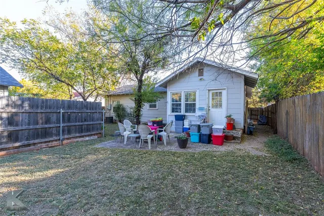 a view of backyard of house with seating space