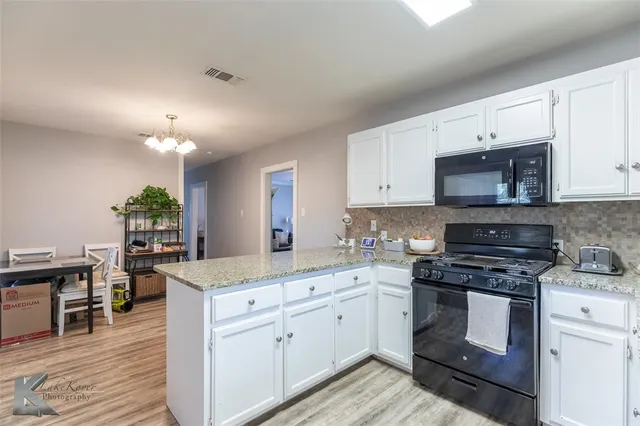 a kitchen with a sink stove and cabinets