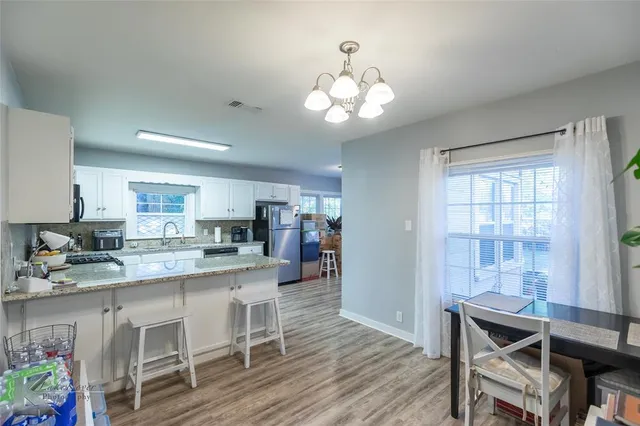 a large kitchen with a table and chairs