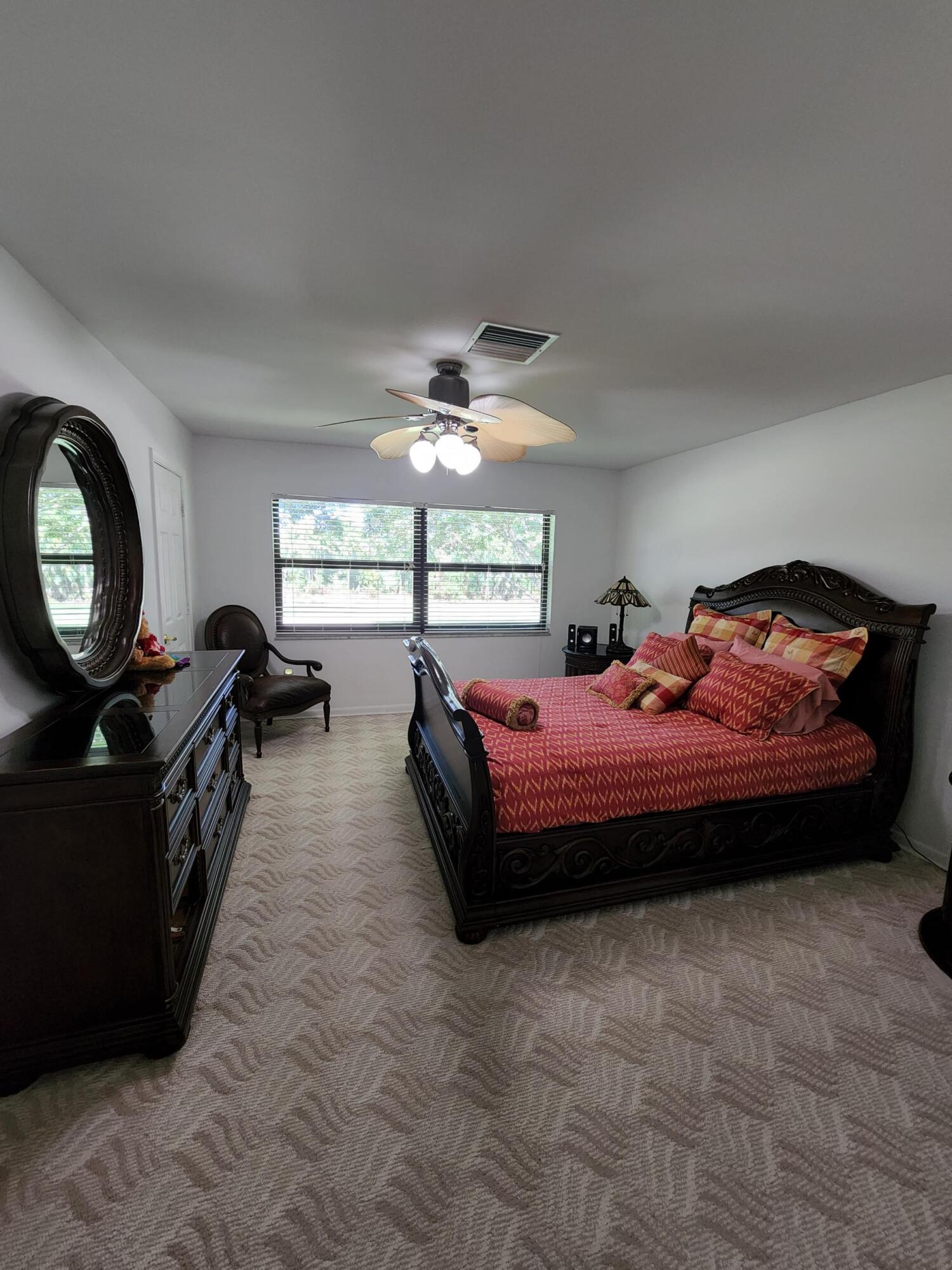 21506 Juego Circle, Unit 28H Boca Raton, FL 33433 - Photo 12 of 21 a bed room with a bed mirror and a window
