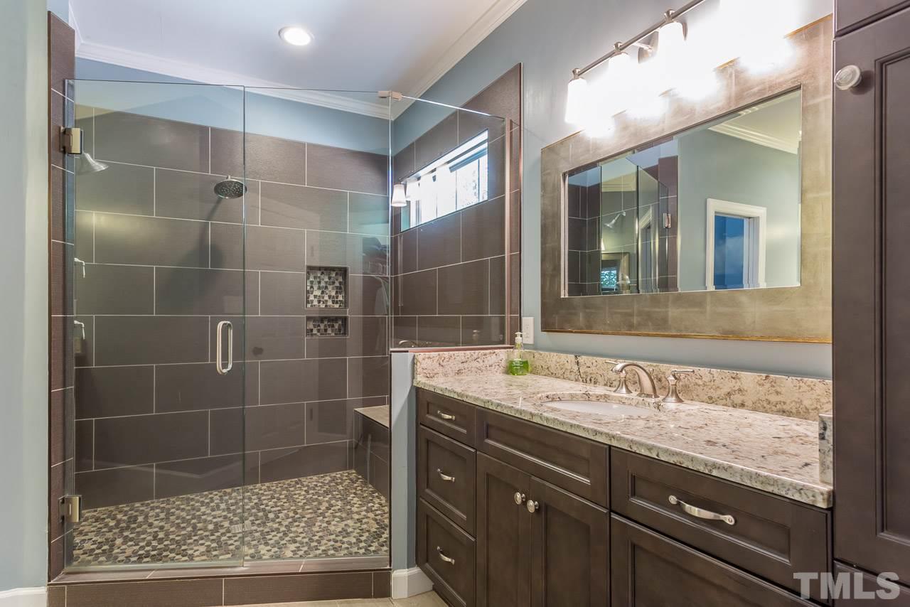 5004 Big Creek Road Raleigh, NC 27613 - Photo 12 of 25 Master bath has been completely renovated with new tile shower, his/her vanities, new tile flooring.