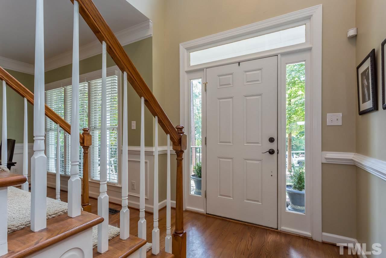 5004 Big Creek Road Raleigh, NC 27613 - Photo 3 of 25 Front door graced with transom windows. Beautiful hardwood floors.
