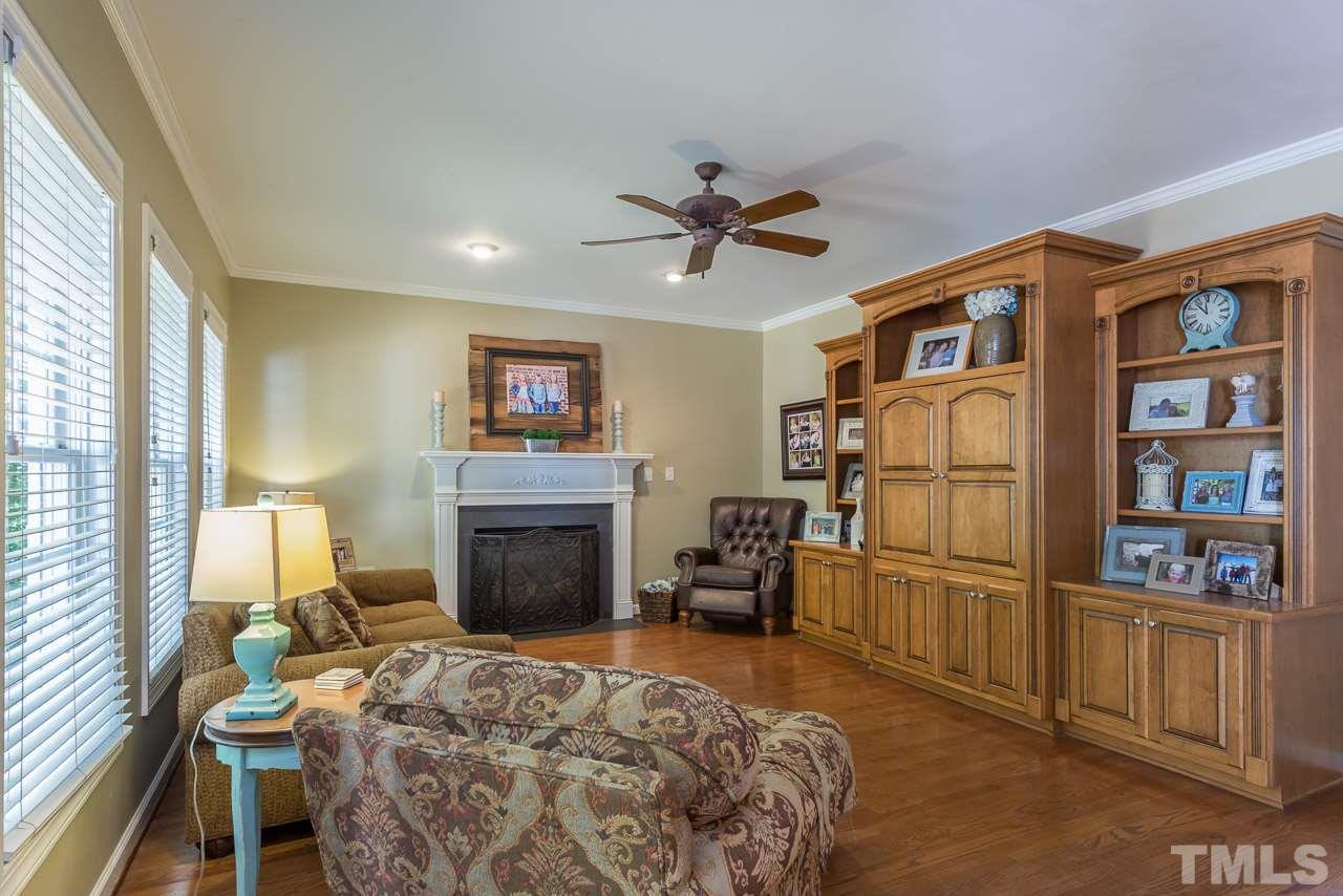 5004 Big Creek Road Raleigh, NC 27613 - Photo 5 of 25 Is open to the kitchen. Graced with hardwood floors, gas log fireplace and a custom made entertainment center.
