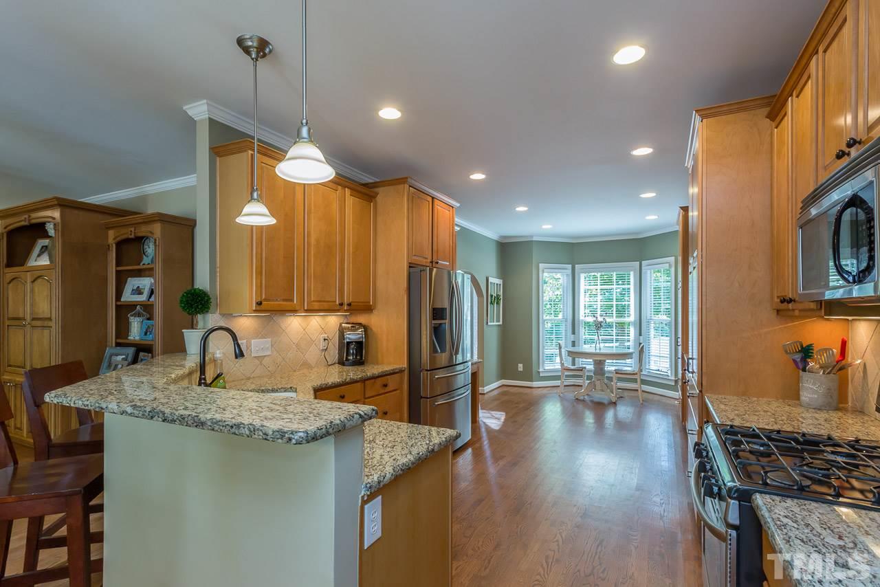 5004 Big Creek Road Raleigh, NC 27613 - Photo 7 of 25 Updated kitchen with granite counters, stainless appliances and additional cabinets were added by owners.