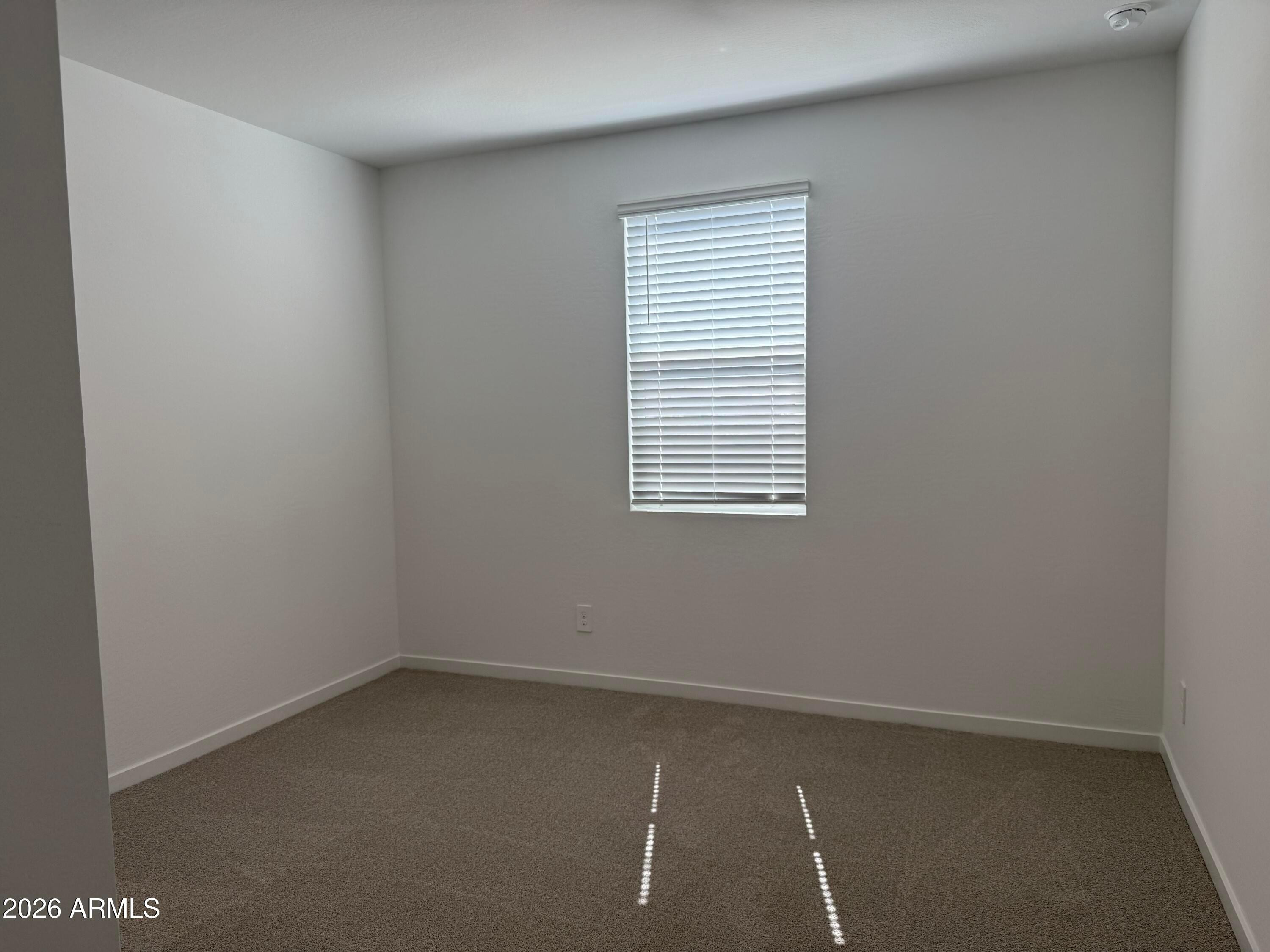 2478 Grenache Road San Tan Valley, AZ 85143 - Photo 16 of 34 an empty room with a window