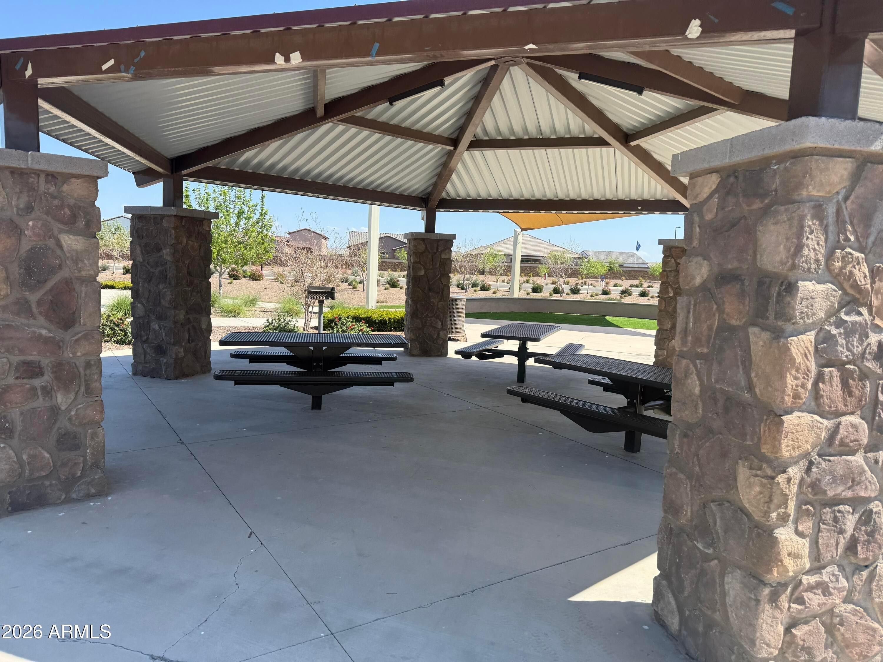 2478 Grenache Road San Tan Valley, AZ 85143 - Photo 25 of 34 a view of a patio with a table and chairs under an umbrella