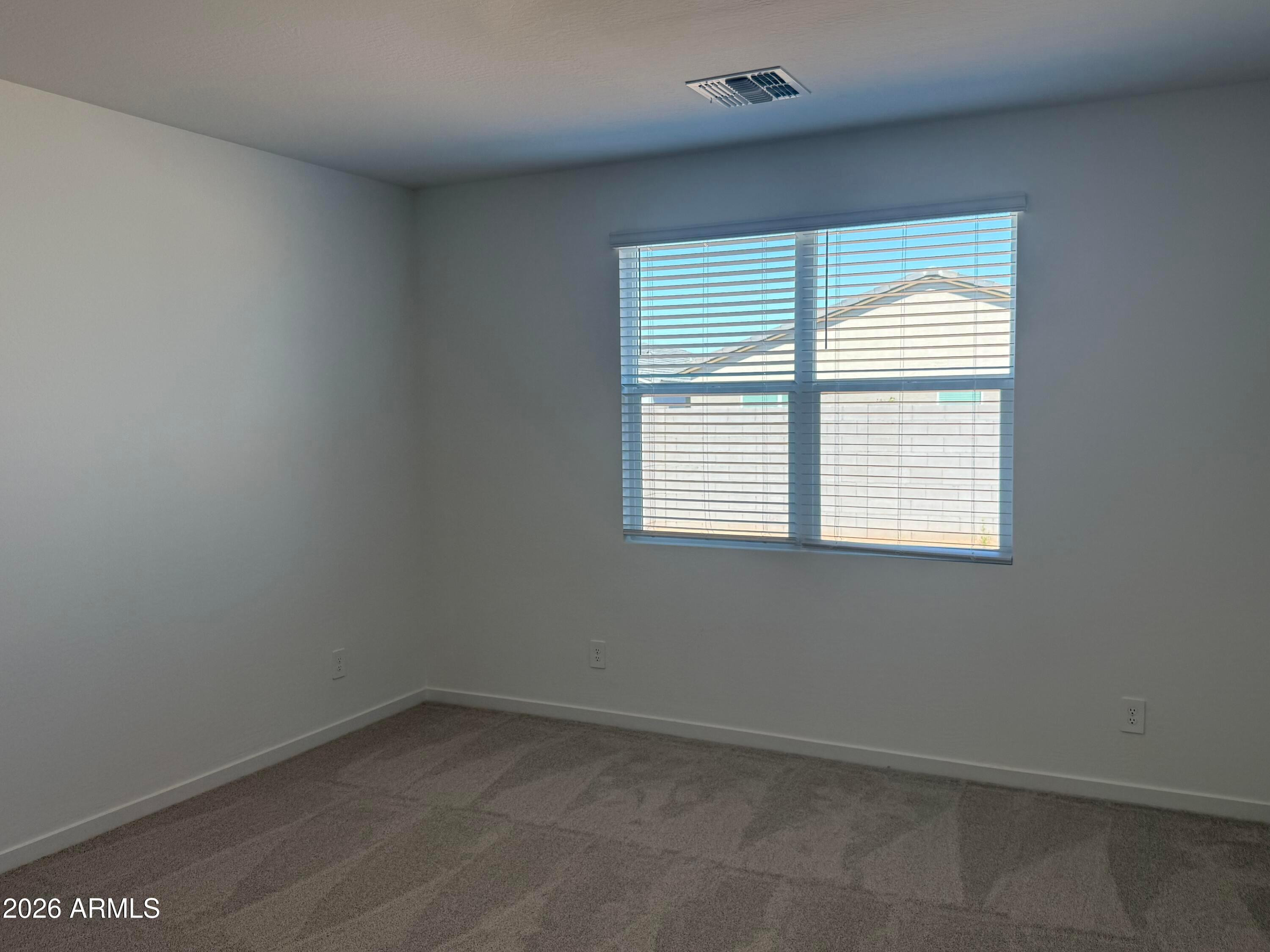 2478 Grenache Road San Tan Valley, AZ 85143 - Photo 7 of 34 an empty room with a window