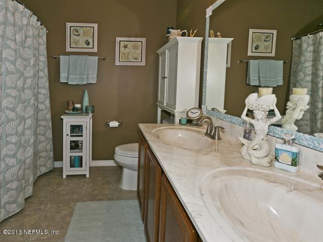 216 Michelangelo Place St. Augustine, FL 32084 - Photo 11 of 18 a bathroom with a granite countertop sink a toilet and shower