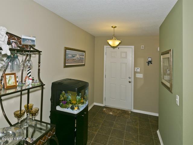 216 Michelangelo Place St. Augustine, FL 32084 - Photo 3 of 18 a bathroom with a light fixture and a glass door