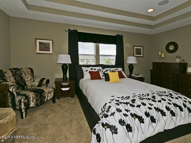 216 Michelangelo Place St. Augustine, FL 32084 - Photo 9 of 18 a bed sitting in a bedroom next to a window