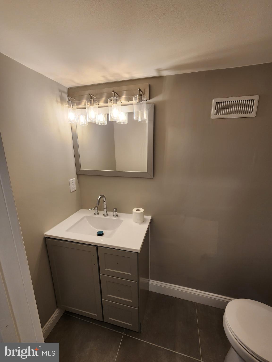9 Bancroft Road Marlton, NJ 08053 - Photo 25 of 27 a bathroom with a sink mirror and toilet