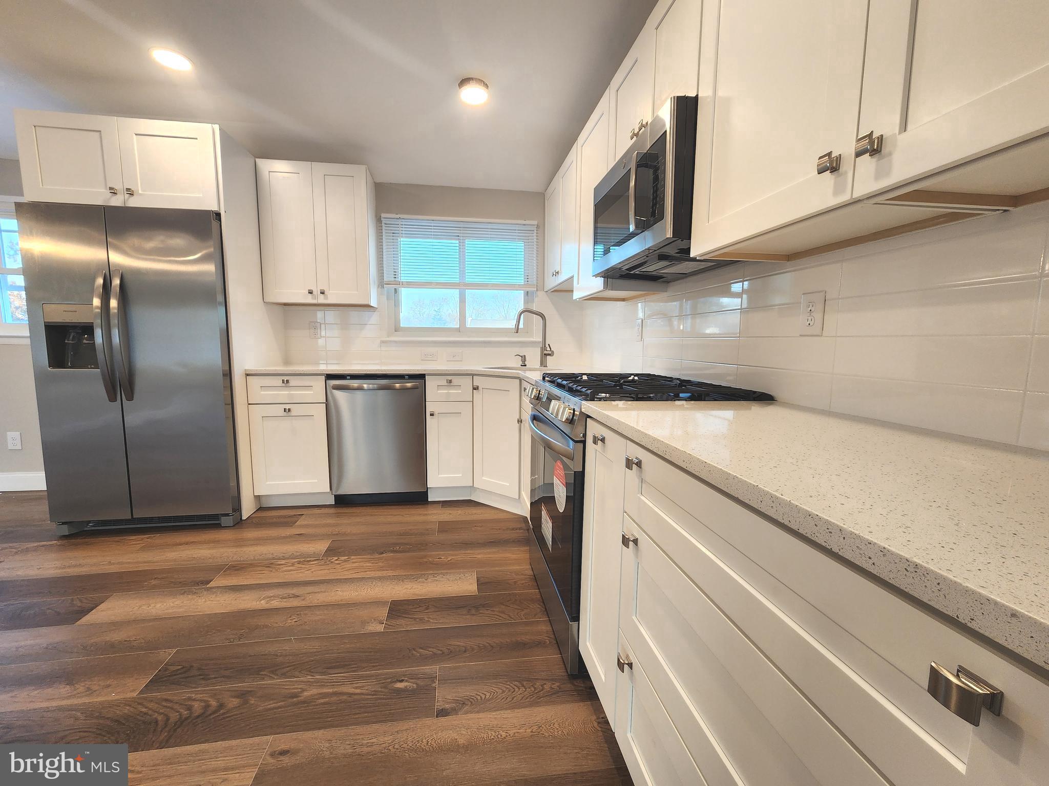 9 Bancroft Road Marlton, NJ 08053 - Photo 4 of 27 a kitchen with stainless steel appliances granite countertop a stove a sink and a refrigerator