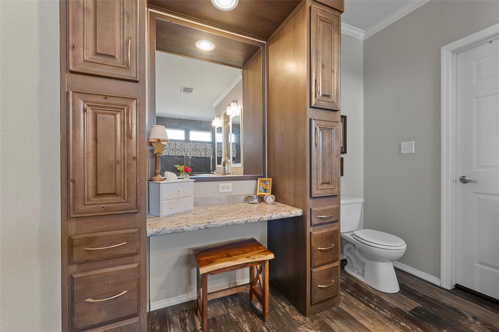 3449 Bluhm Road West, TX 76691 - Photo 18 of 40 Bathroom featuring dark wood-style floors, crown molding, and vanity