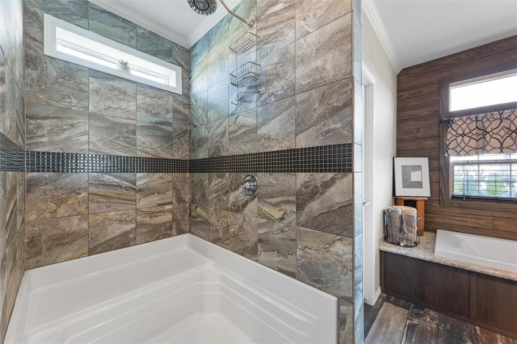 3449 Bluhm Road West, TX 76691 - Photo 21 of 40 Full bath featuring a stall shower, a garden tub, crown molding, and wood finished floors