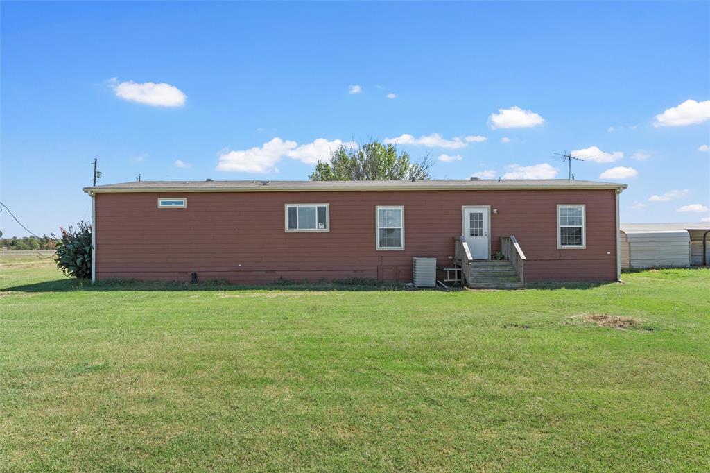 3449 Bluhm Road West, TX 76691 - Photo 32 of 40 Back of property featuring a yard and entry steps