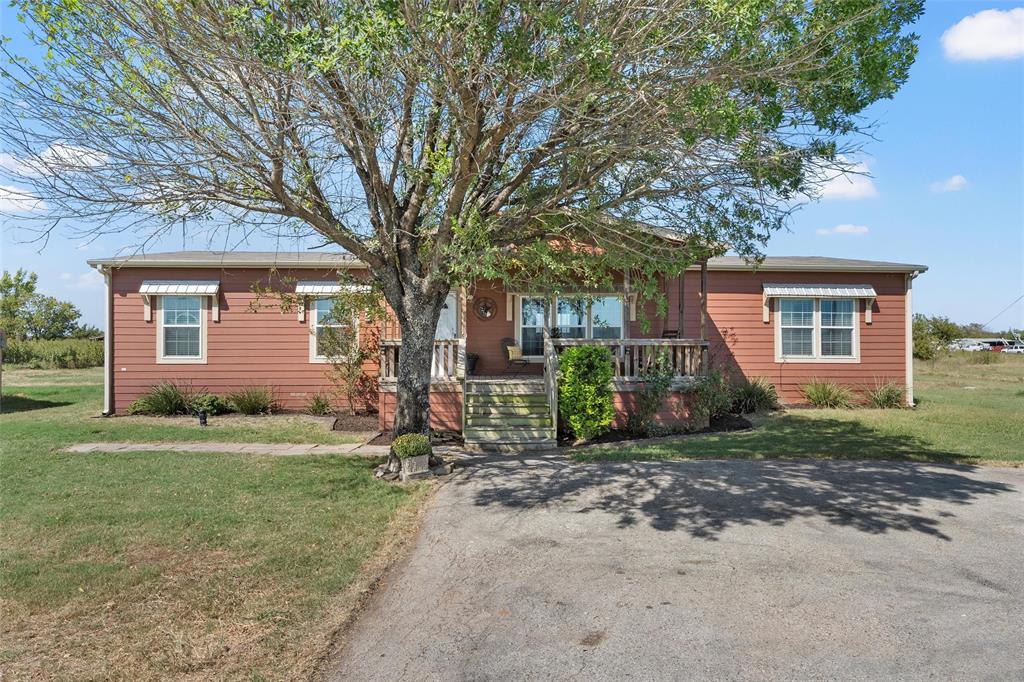 3449 Bluhm Road West, TX 76691 - Photo 4 of 40 View of front facade featuring a front lawn and a porch