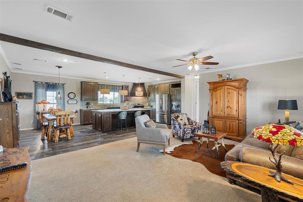 3449 Bluhm Road West, TX 76691 - Photo 8 of 40 Living room with ornamental molding, dark wood-style floors, ceiling fan, beamed ceiling, and recessed lighting