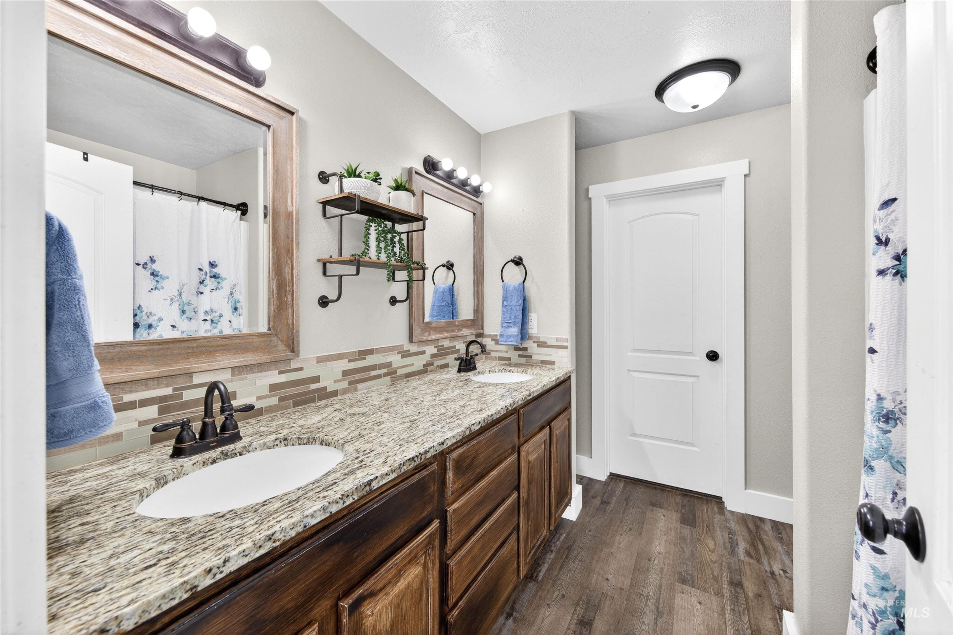 4 Round Up Circle Boise, ID 83716 - Photo 25 of 47 Bathroom featuring a double vanity with granite-style countertops and undermount sinks