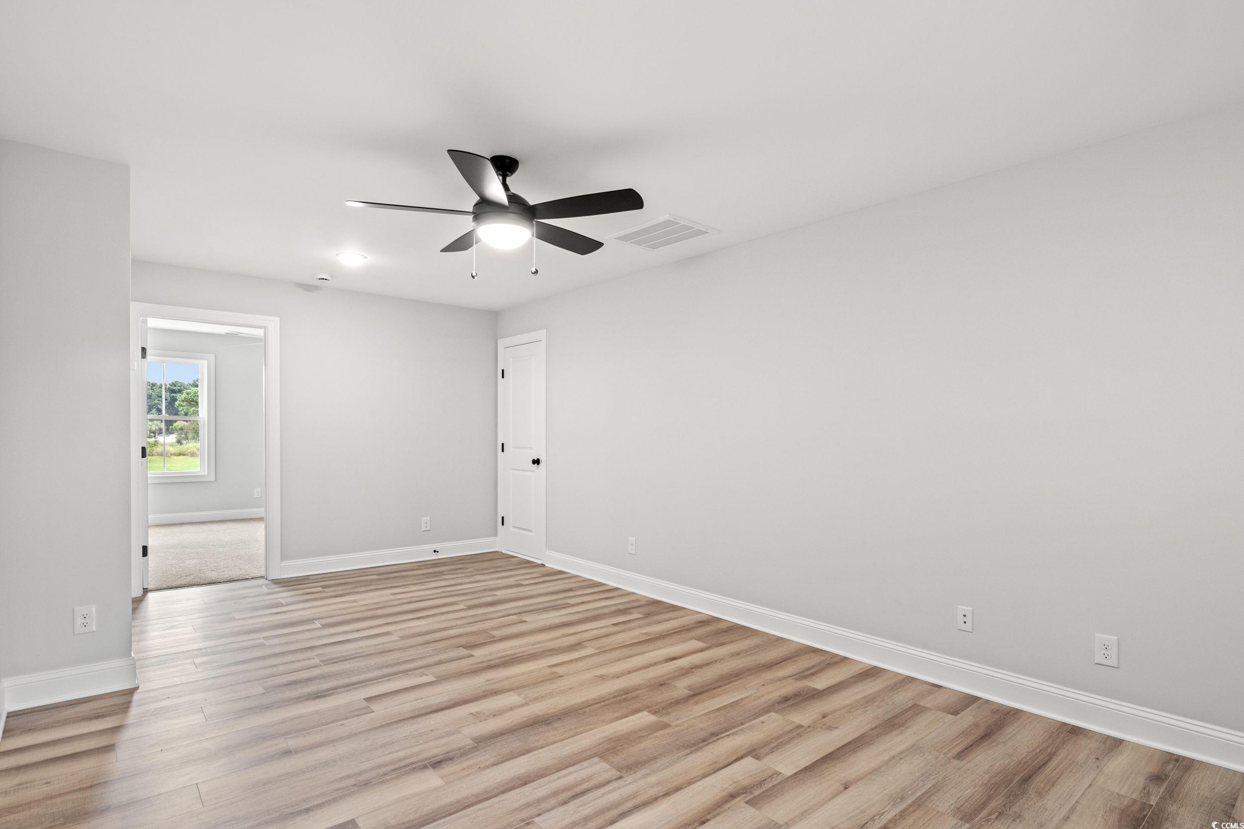 1509 Crooked Hook Road North Myrtle Beach, SC 29582 - Photo 15 of 40 Empty room with light hardwood / wood-style floori