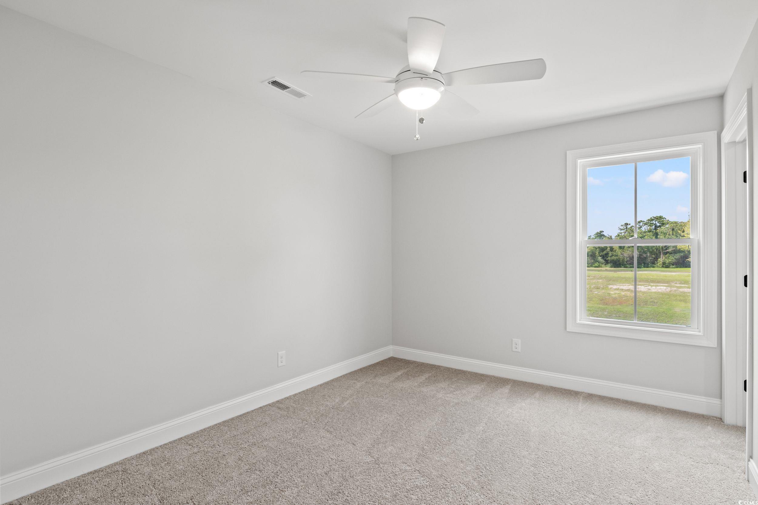 1509 Crooked Hook Road North Myrtle Beach, SC 29582 - Photo 21 of 40 Carpeted empty room with ceiling fan