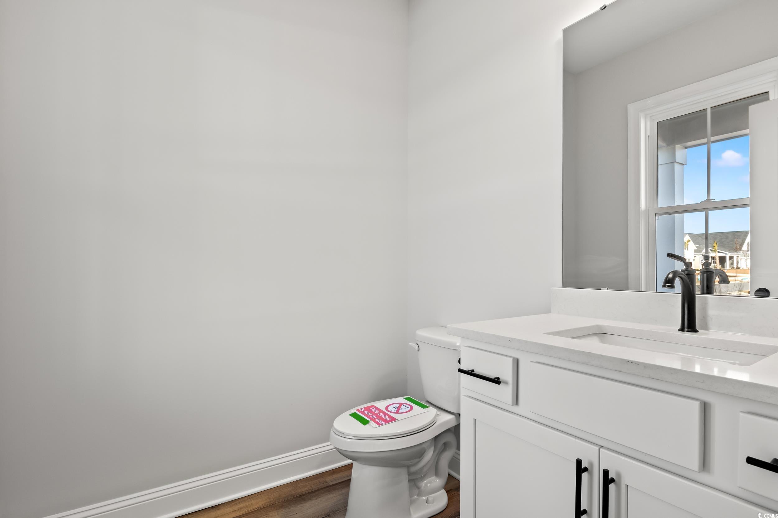 Bathroom with hardwood / wood-style floors, vanity