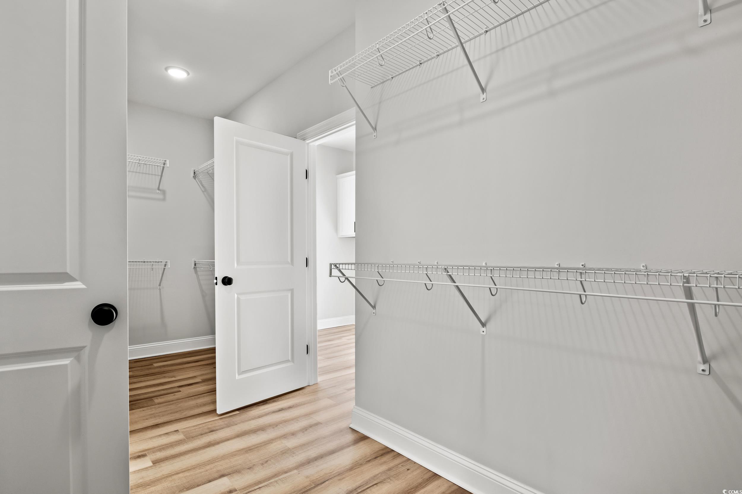 1509 Crooked Hook Road North Myrtle Beach, SC 29582 - Photo 8 of 40 Walk in closet featuring hardwood / wood-style flo