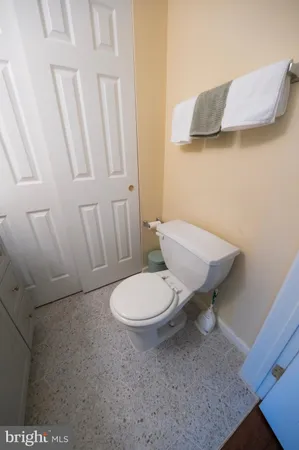 a white toilet sitting next to a sink