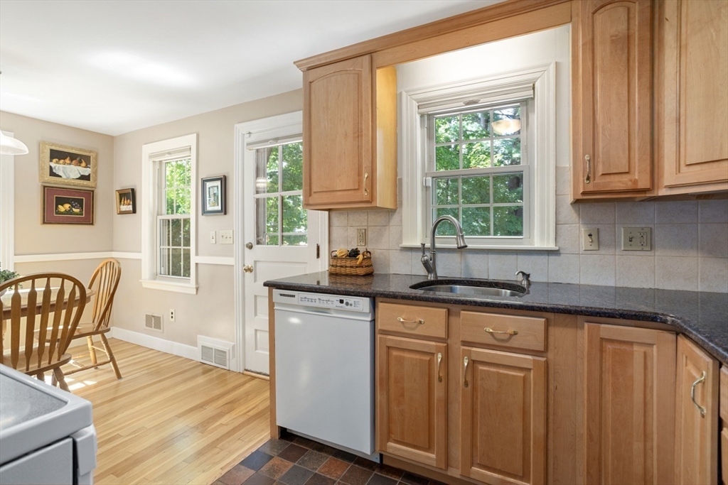 42 Sturges Road Reading, MA 01867 - Photo 13 of 42 a kitchen with stainless steel appliances granite countertop white cabinets a sink and dishwasher with wooden floor