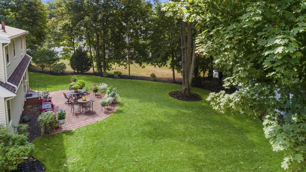 42 Sturges Road Reading, MA 01867 - Photo 36 of 42 a view of a table and chairs in the garden