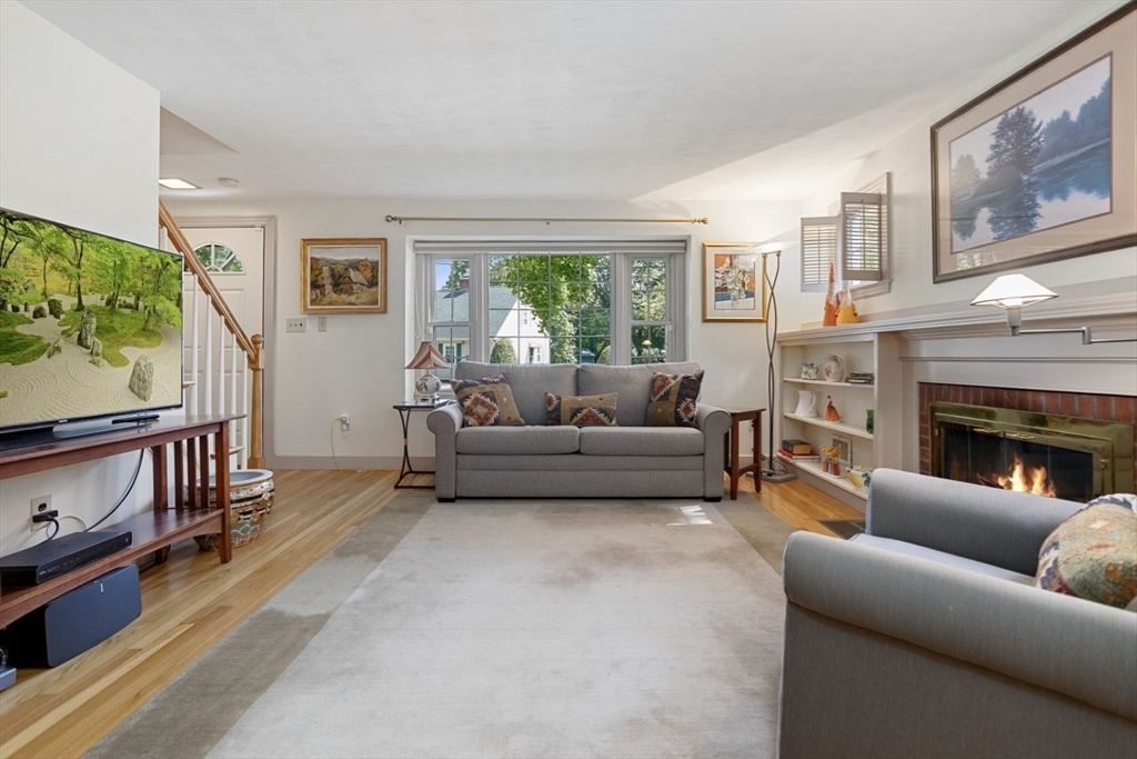 42 Sturges Road Reading, MA 01867 - Photo 10 of 42 a living room with furniture a large window and a fireplace