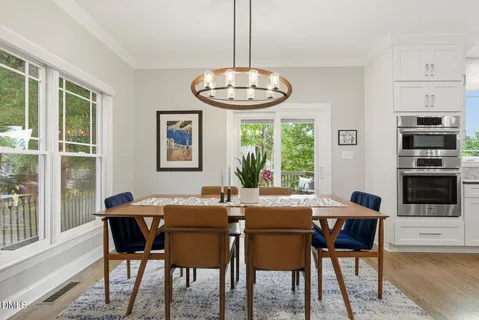 a view of a dining room with furniture window and wooden floor
