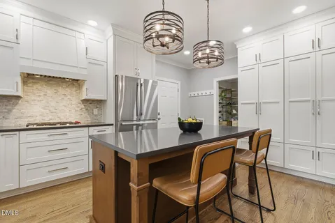 a kitchen with stainless steel appliances granite countertop a sink and a granite counter tops with a large window