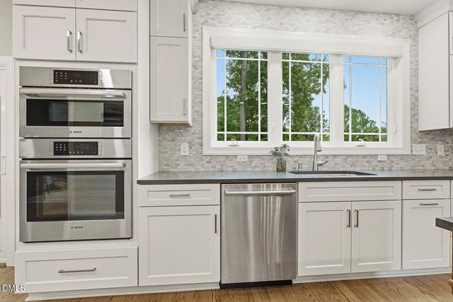 a kitchen with a table and a window